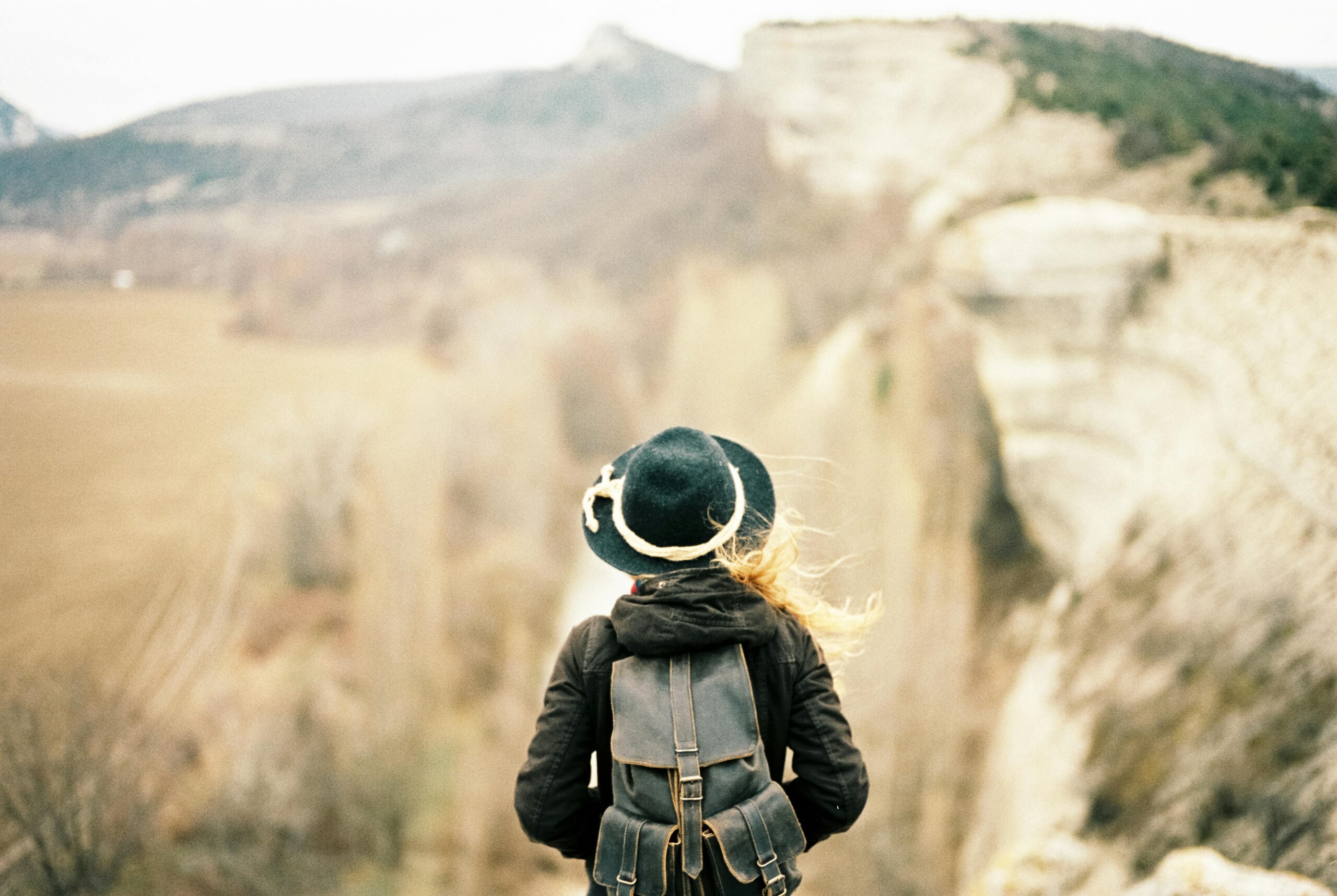 pexels-photo-4510854-4510854 A woman with a backpack admires a stunning mountain view, symbolizing adventure.